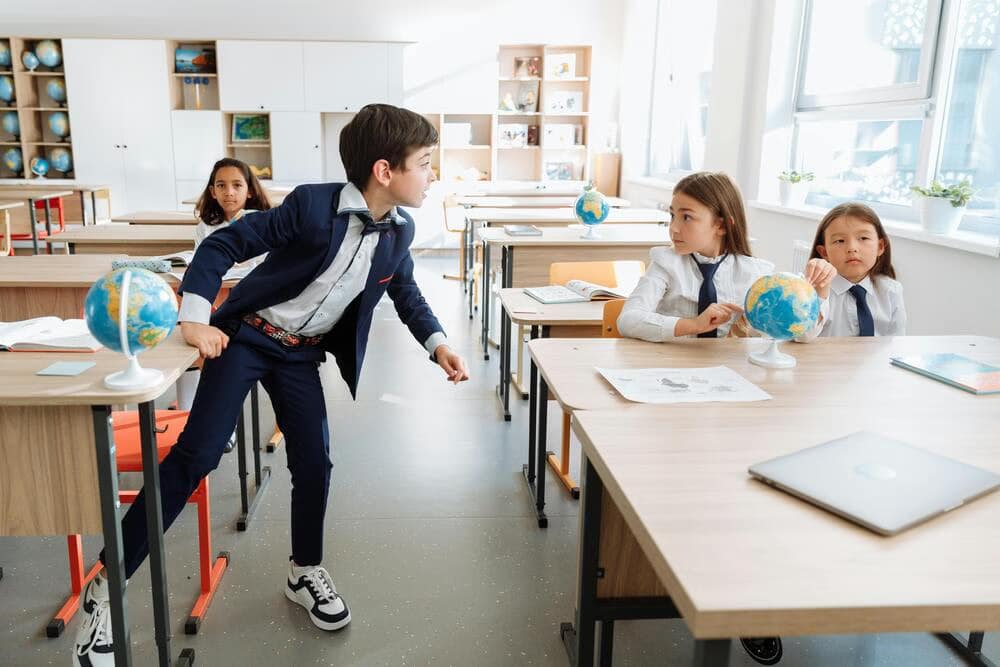 Students in a classroom with one boy standing up-5 Silent Battles That Break Teachers No One Talks About.