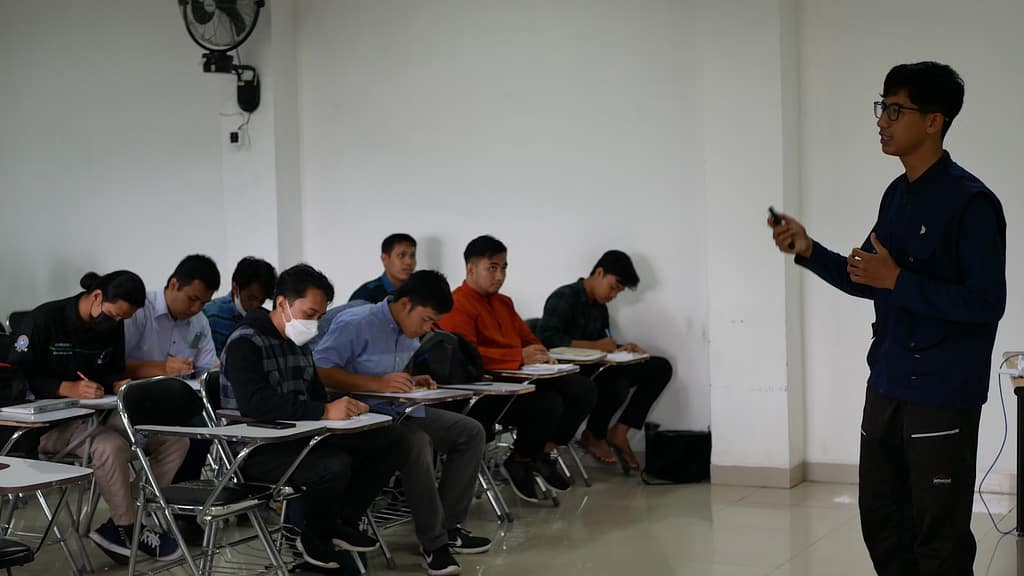 a man standing in front of a classroom full of students-The Daily Academic Tightrope Teachers Walk You Didn't Know About