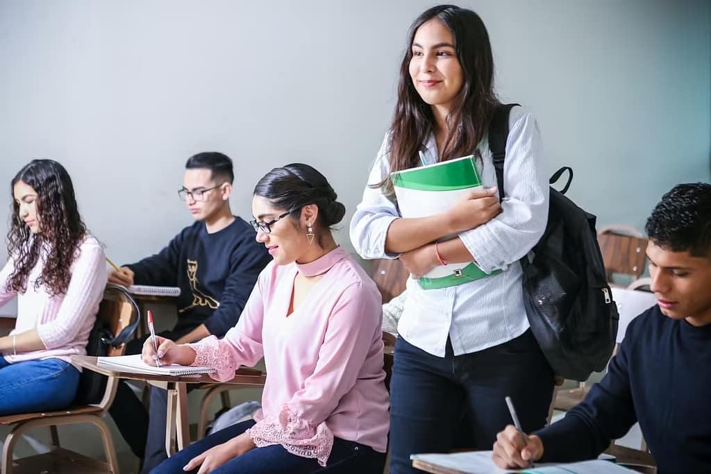 woman carrying white and green textbook-How to Become a Healthy Smart Student