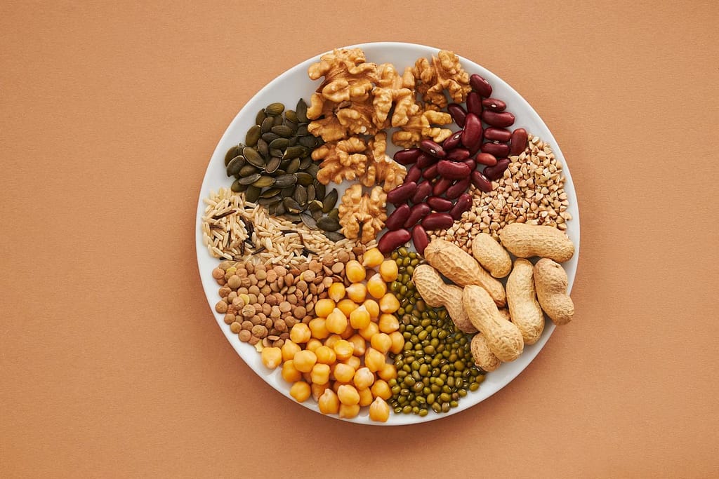 Top view of nuts, beans, and seeds on a plate, ideal for healthy dining themes.How to Optimize Metabolic Health Naturally