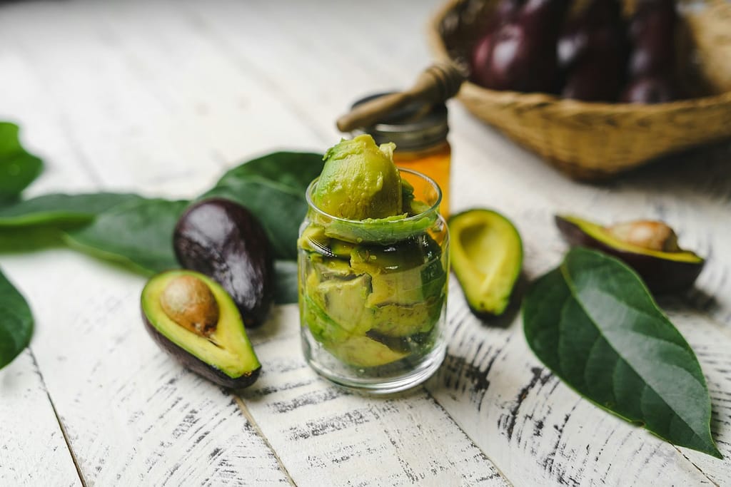 Avocados and green tea in clear glass cup