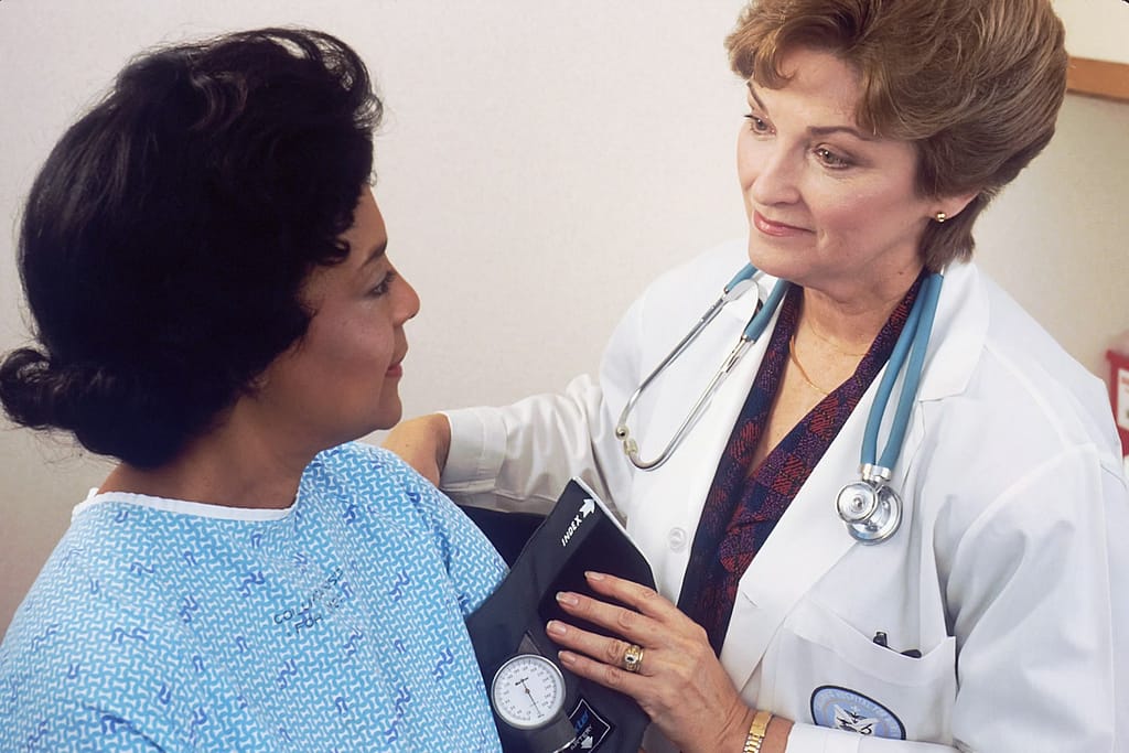 a woman with a stethoscope talking to another woman doctor measuring her blood pressure-High Blood Pressure Medications Alternatives You Should Know