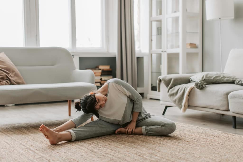an woman doing stretches at home-The Benefits of Stretching Every Morning You Should Know