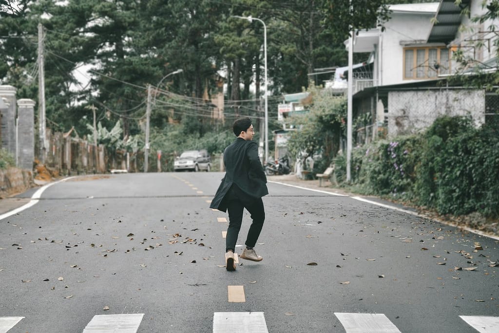 man in black jacket walking on sidewalk during daytime-How to Fix the Effects of Stress on Your Body