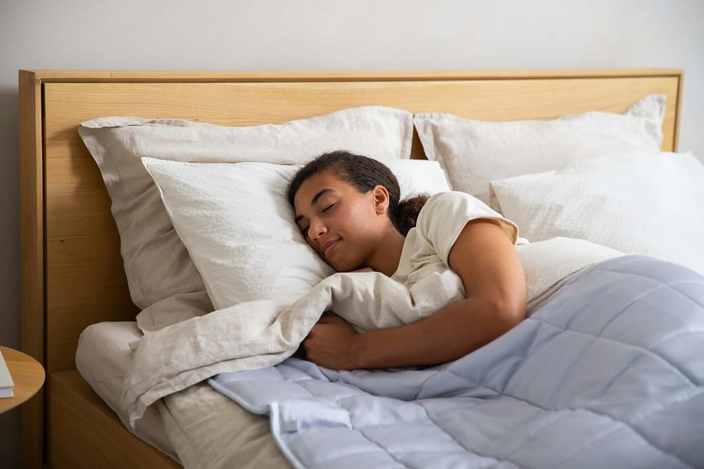 a young girl sleeping in a bed with white sheets-What Current Research Really Says