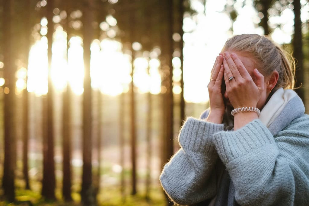woman wearing gray coat with hands on her face during daytime-What Current Research Really Says