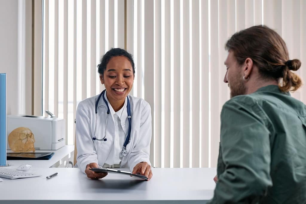 A doctor and patient engaging in a positive consultation in a bright clinic setting-Proven Ways to Crush Stress Belly Fat for Good