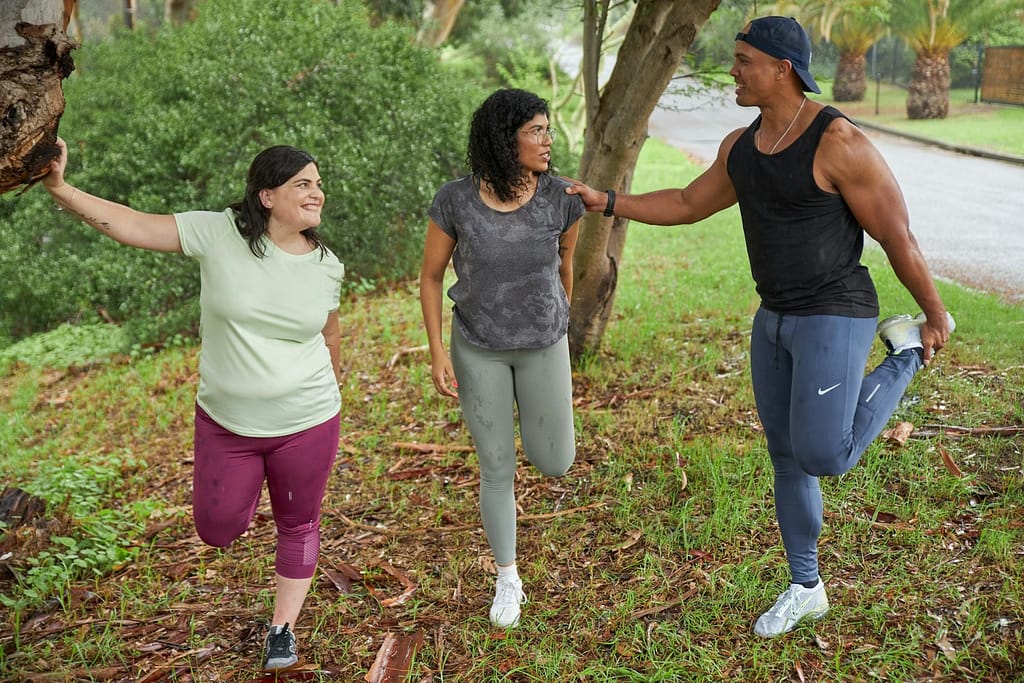 Three people stretch before a run on a rainy day-How to Make Health and Fitness a Hobby