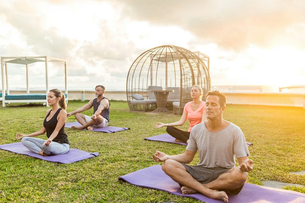 people practicing yoga on green grass field-Rewire Your Brain: The Secret to a Longer Life