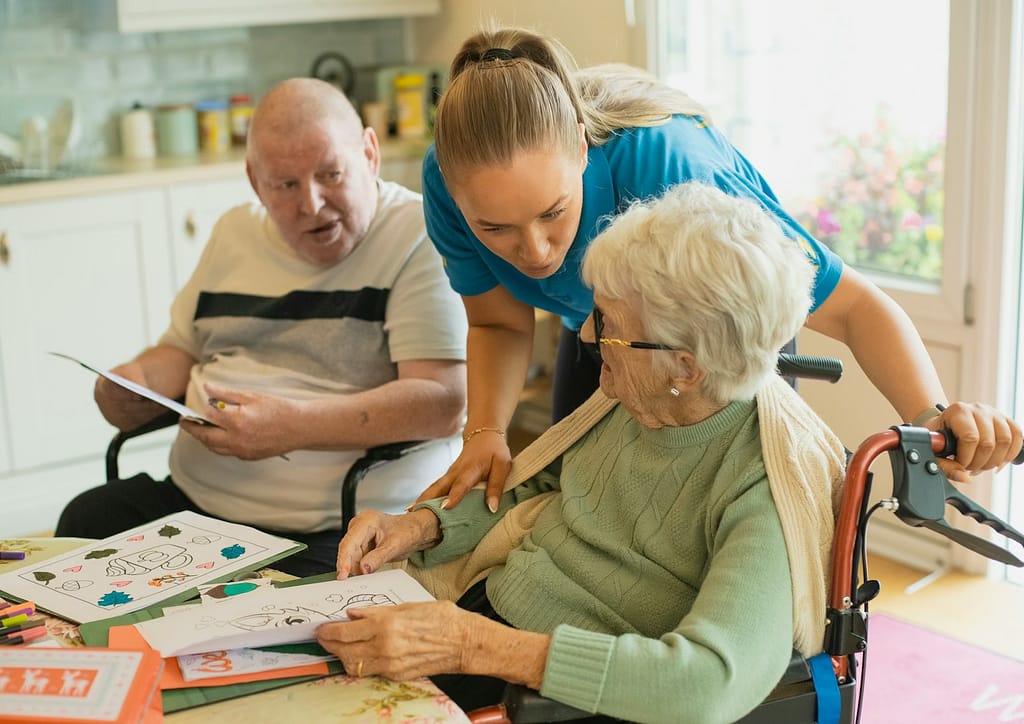 Caregiver assisting elderly couple with coloring-What Current Research Really Says