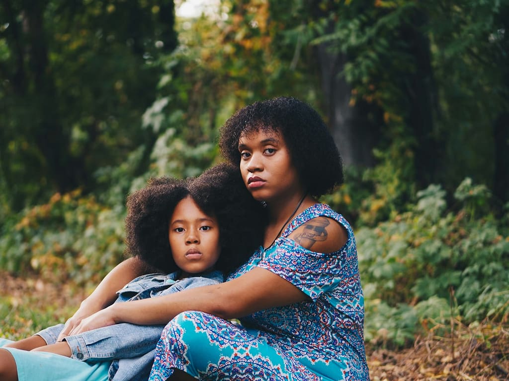 woman sitting in front of child sitting beside trees-Can Trauma Be Passed Down Through Generations?