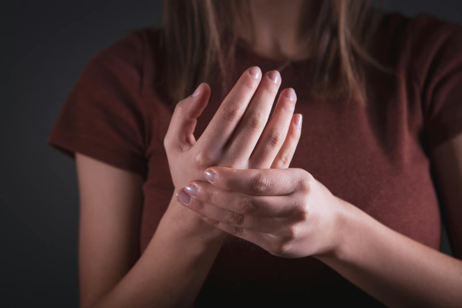 Woman holding her hand with pain-How to Reduce Inflammation with Plants