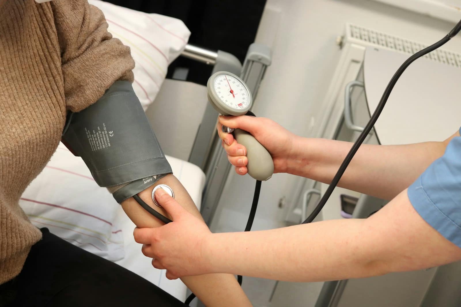 A person with a blood pressure device in their hand-Why Healthy People Still Have High Blood Pressure