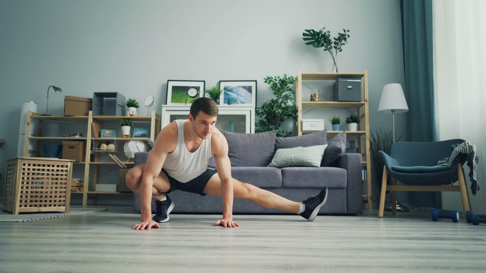 a man stretching in front of a couch-The Ultimate Guide to Getting Fit in 10-15 Minutes a Day