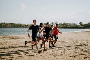 men and women running on sea shore-The Best Cardio Workouts for Burning Fat Fast