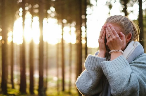 woman wearing gray coat with hands on her face during daytime-What Current Research Really Says
