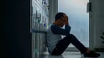 man in gray long sleeve shirt and black pants sitting on white floor tiles-How to Fix the Effects of Stress on Your Body
