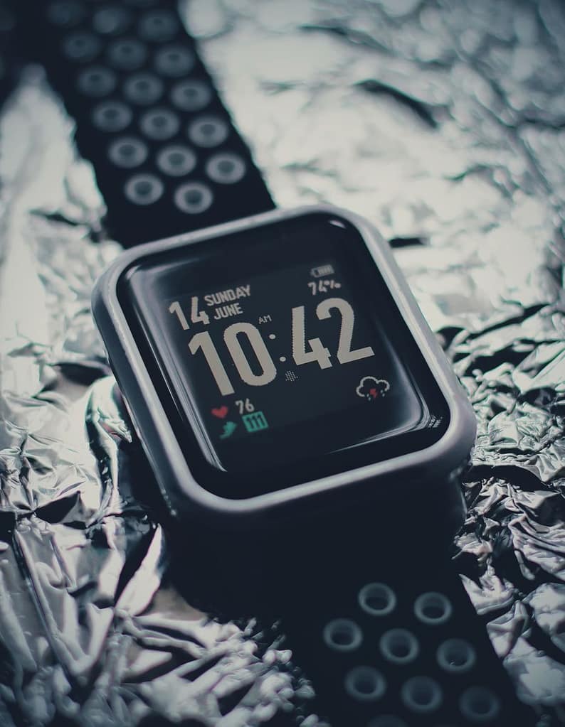 Stylish black smartwatch with digital display showing time and date on shiny foil background-The Shocking Truth About $80 Fitness Trackers You Didn't Know