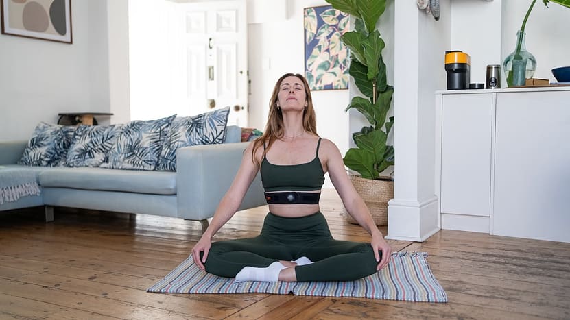a woman sitting on a yoga mat in a living room-10 Creative Ways to Improve Your Thinking Skills