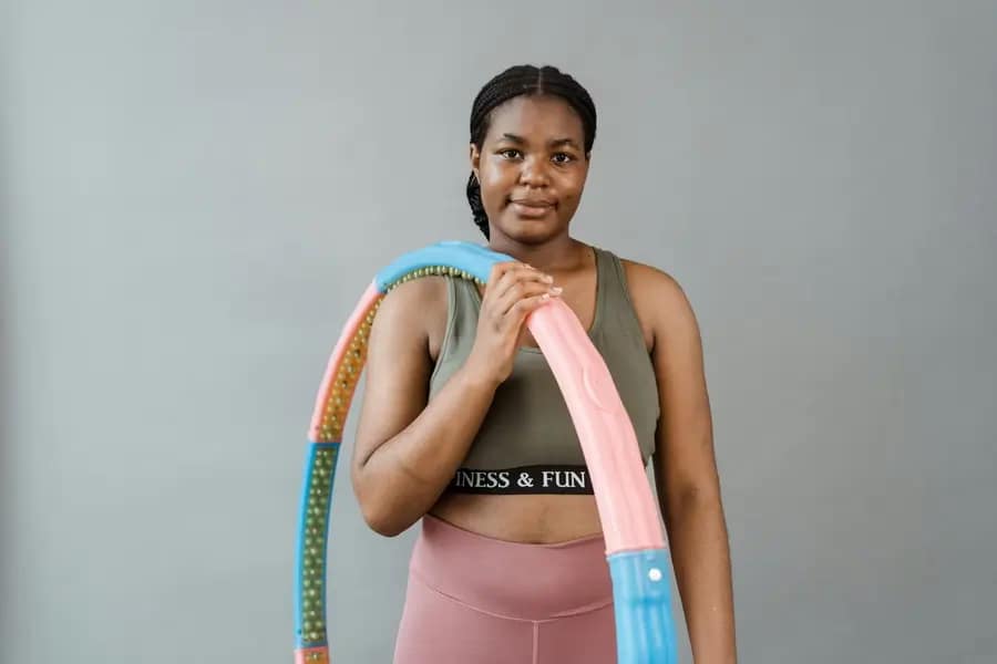 A-young-black-lady-holding-a-hula-hoop-Proven Ways to Maintain A Healthy Weight Long-Term
