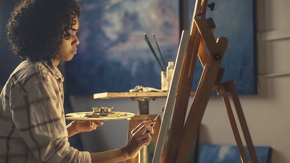 a young woman painting-10 Creative Ways to Improve Your Thinking Skills